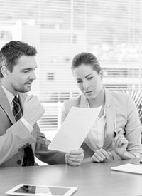 Business colleagues discussing paperwork